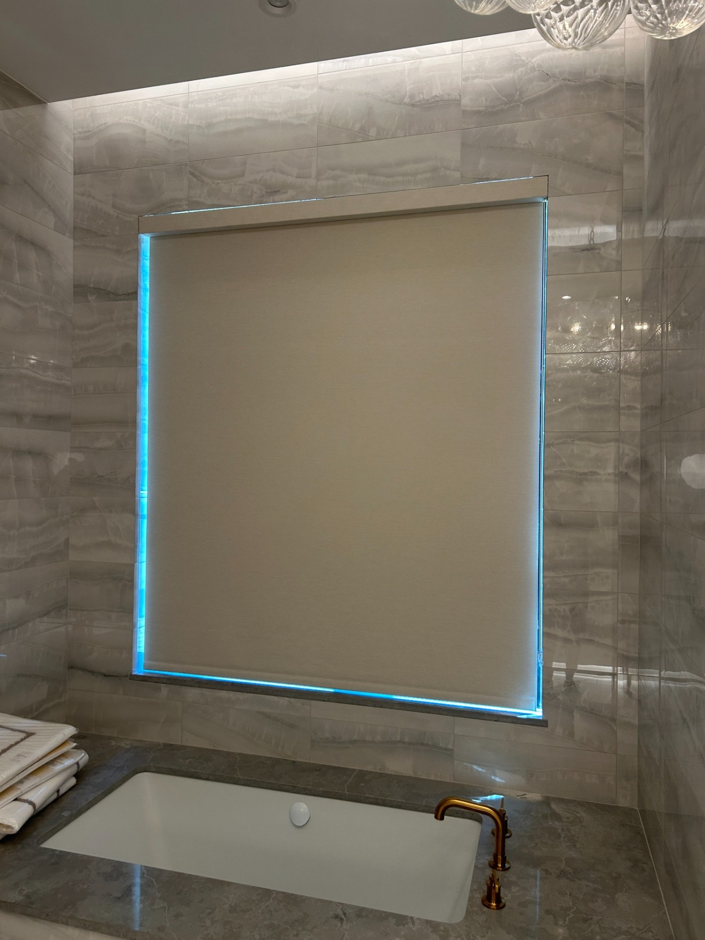 Motorized roller shade in luxury bath